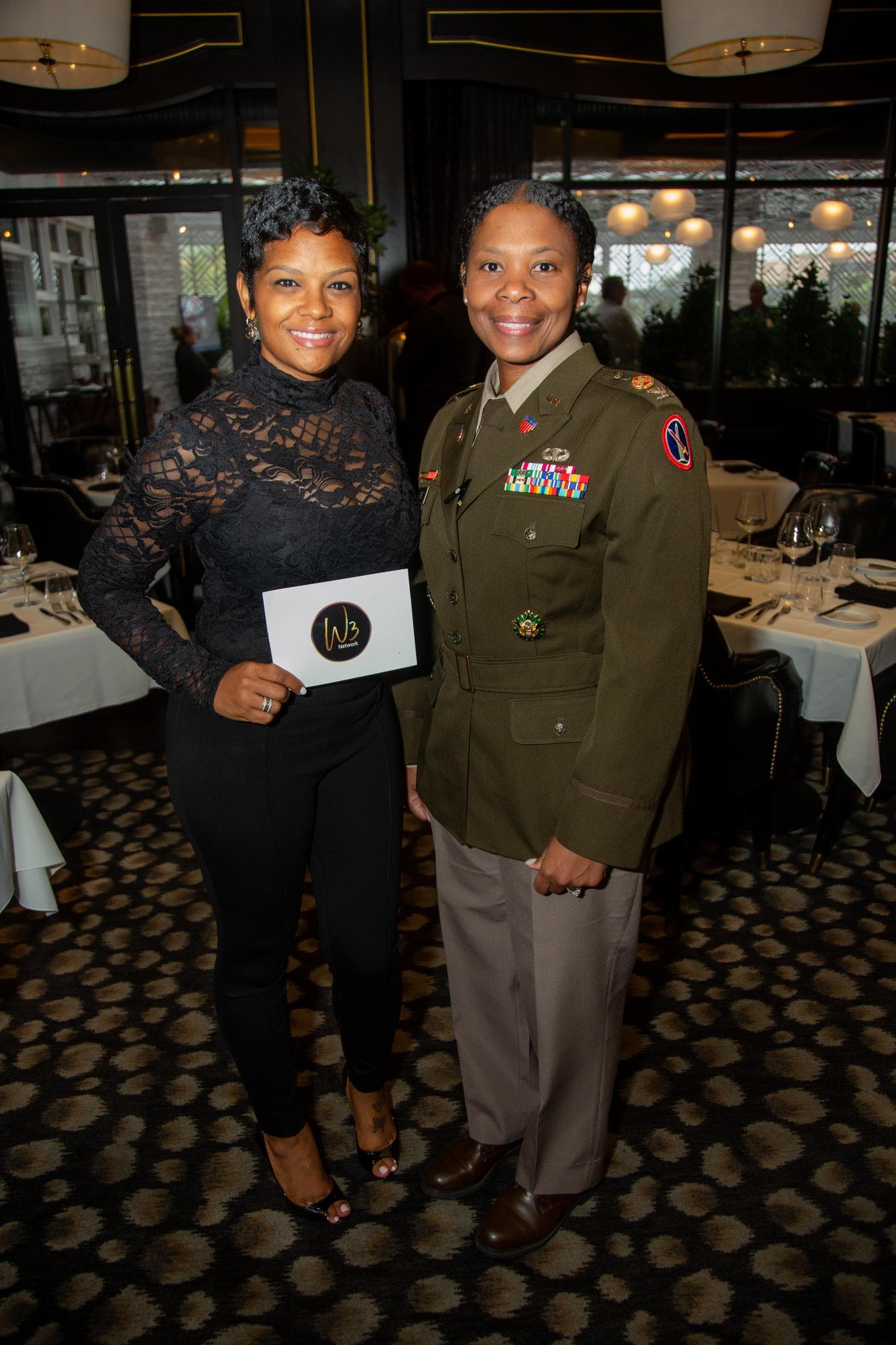 Women entrepreneurs networking at an elegant dinner event hosted by Women Winning Worldwide